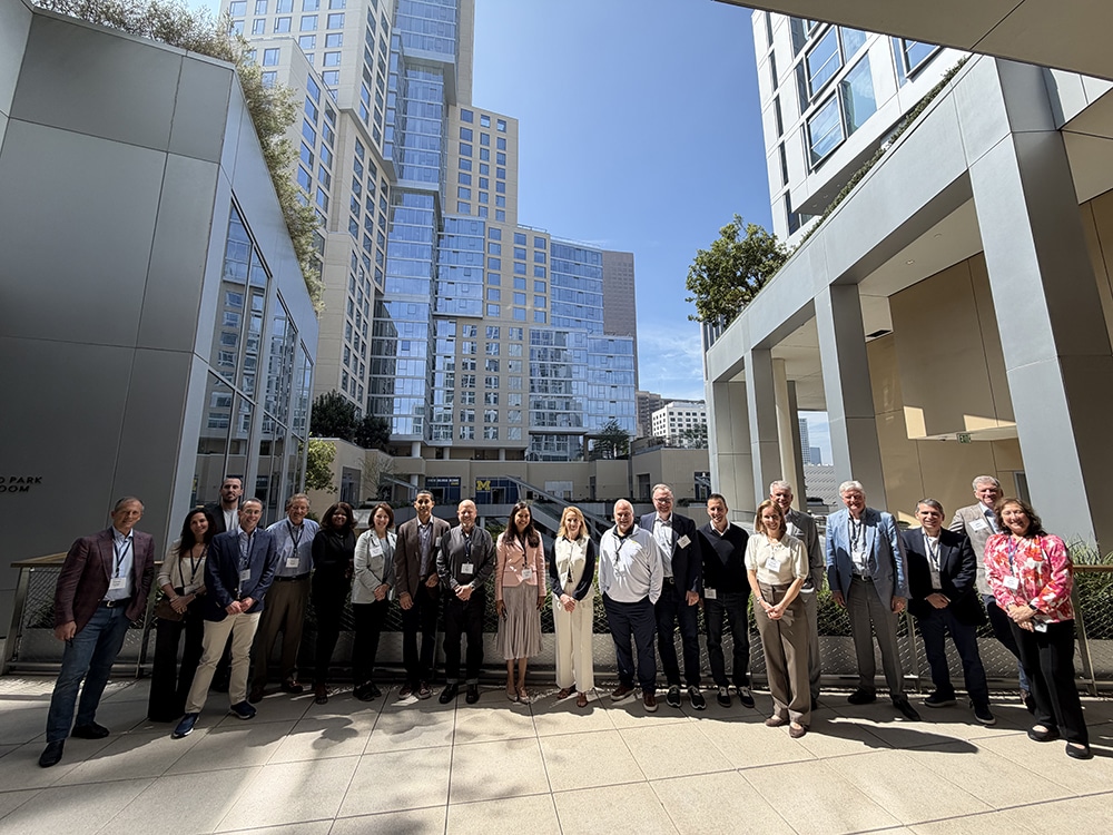 The Ross School Advisory Board meeting in Los Angeles - the board members smiling with the new Michigan Ross Los Angeles building in the background