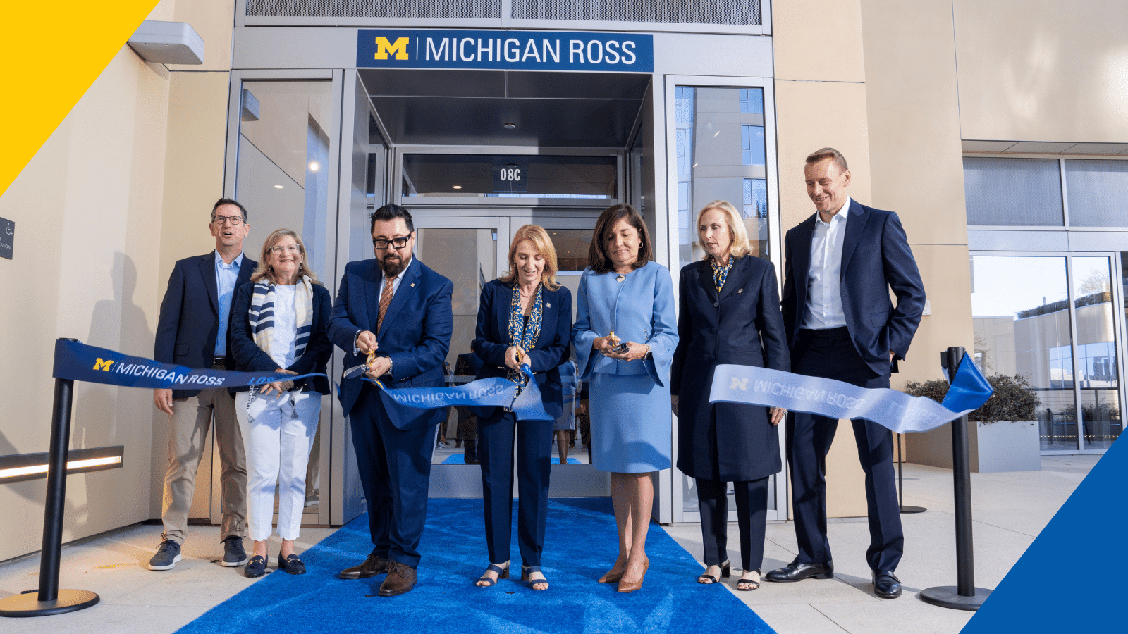 A group of people cutting a ribbon in front of the new Michigan Ross Los Angeles campus