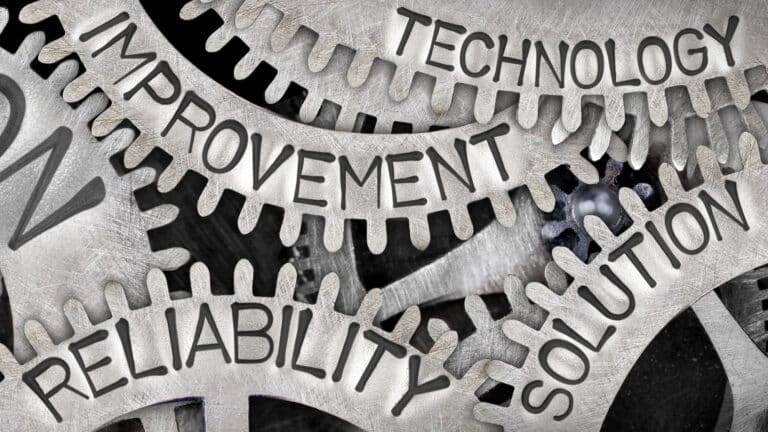 Metal gears with the words Technology, Improvement, Reliability, and Solution