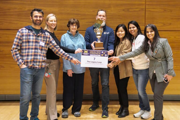 Don DuChateau, Sheetal Sonar, and their team holding the Hacks With Friends Trophy