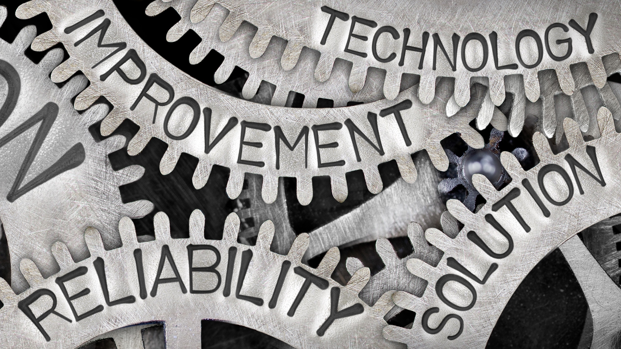 Metal gears with the words Technology, Improvement, Reliability, and Solution
